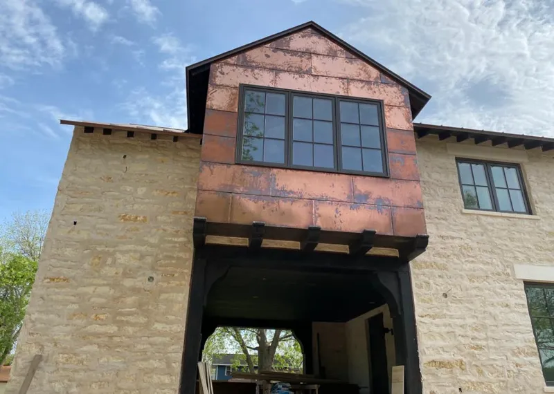 Copper metal panel facade on a stone building for Roof Repair in North Ridgeville